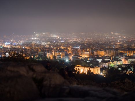 The city of Athens iluminated at night view from Acropolis hill