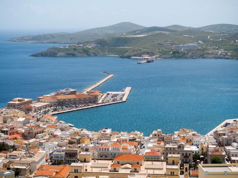 View of Syros town and port with beautiful buildings and houses in a sunny day