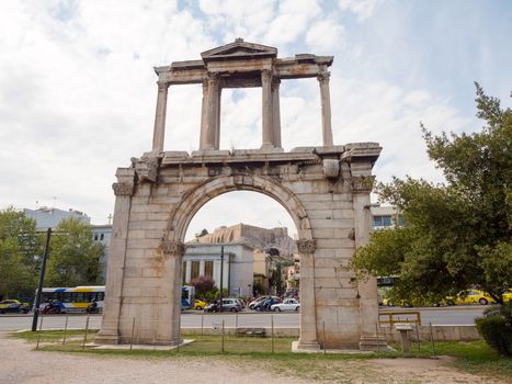 Hadrian's arch with Acropolis on the background in the historic center of Athens, Greece