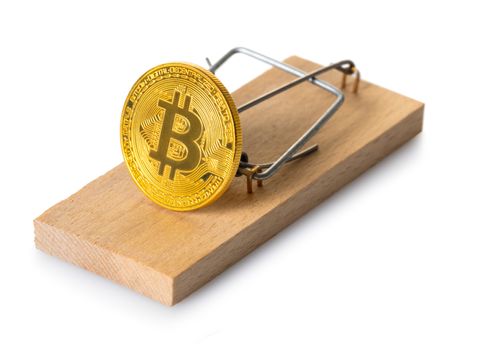 mousetrap with bitcoin on white isolated background