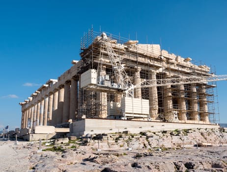 Part of Parthenon temple in Acropolis hill surrounded by scaffolding, Athens, Greece