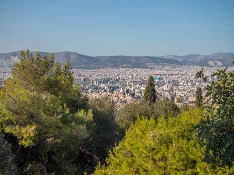Areopagus hill with tourists enjoying the beautiful view of Athens city in the afternoon, Greece