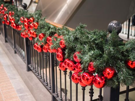 Red Christmas balls decorate the interior of a shopping mall