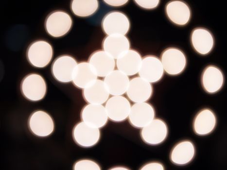 Bokeh of lights creating a shape of a star on a circle