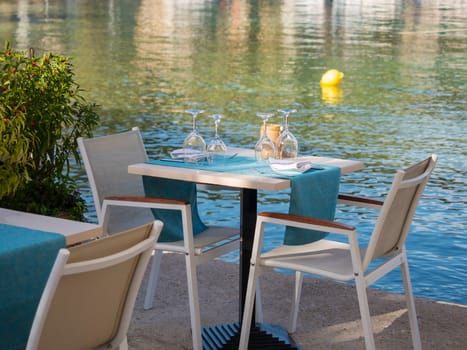 Restaurant tables by the sea in Fiskardo village in Kefalonia island, Greece