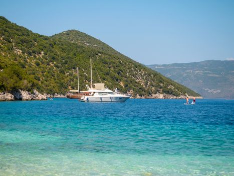 Boats in a shore and people enjoy the summer in Kefalonia island, Greece