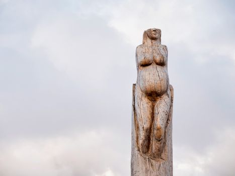 Athens, Greece -  04 January 2017: Wood carving sculptures at the park of lost souls with snow and cloudy sky at Parnitha, Athens, Greece