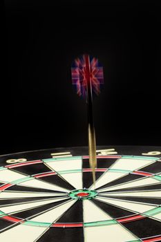 Indoor game Darts on a black studio background