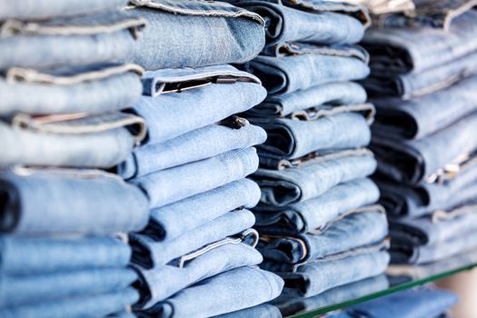 Closeup shot of stack of folded jeans in the fashion store