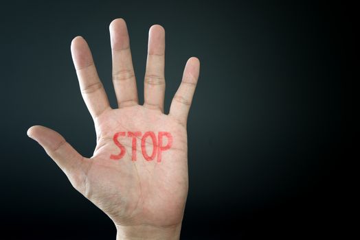 Hand with stop sign isolated on black background