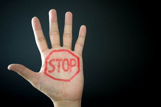 Hand with stop sign isolated on black background