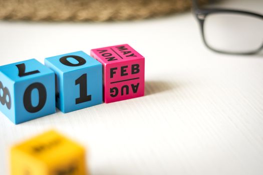 modern perpetual calendar composed of colored cubes and set at the date of February 1st