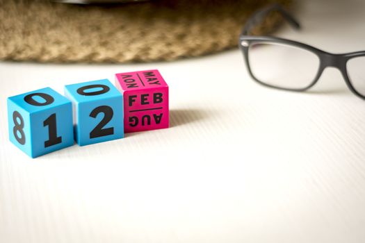 modern perpetual calendar composed of colored cubes and set at the date of February 12th