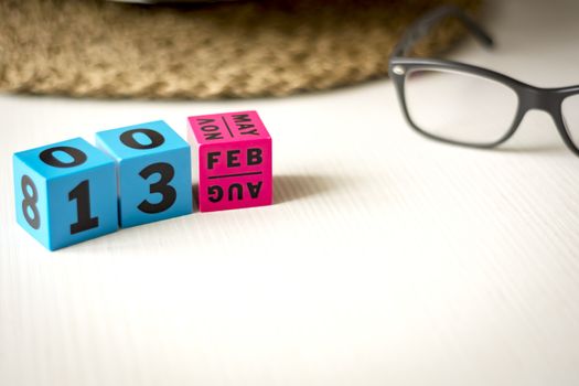 modern perpetual calendar composed of colored cubes and set at the date of February 13th