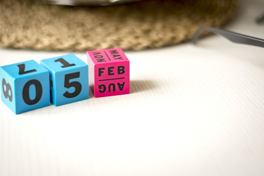 modern perpetual calendar composed of colored cubes and set at the date of February 5th