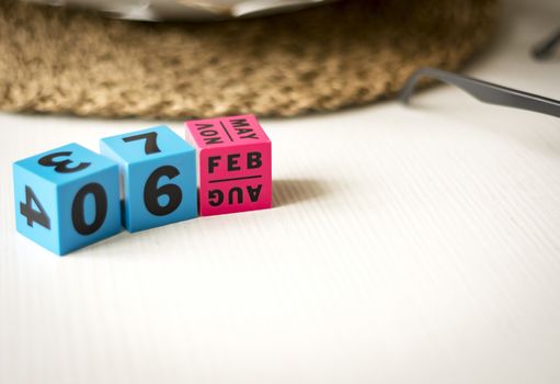 modern perpetual calendar composed of colored cubes and set at the date of February 6th