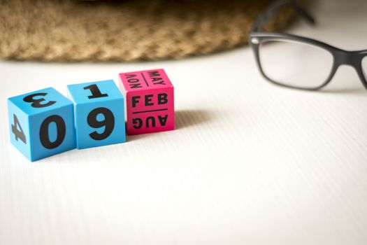 modern perpetual calendar composed of colored cubes and set at the date of February 9th