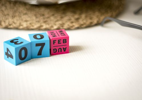 modern perpetual calendar composed of colored cubes and set at the date of February 7th