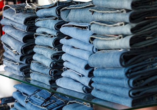 Closeup shot of stack of folded jeans in the fashion store