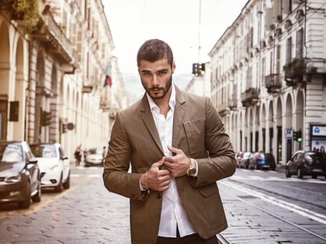 Attractive man outdoor wearing elegant jacket, in European city, Turin in Italy