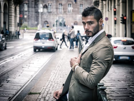 Attractive man outdoor wearing elegant jacket, in European city, Turin in Italy