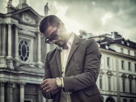 Attractive man outdoor wearing elegant jacket, in European city, Turin in Italy