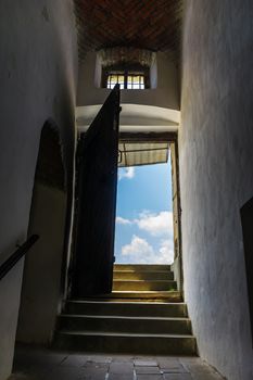 steps through open door in to the sky. view from inside of Palanok castle in Mukachevo, Ukraine