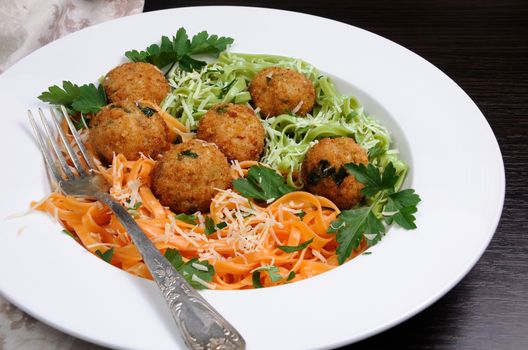 Spaghetti from carrots and spinach with chicken meatballs flavored cheese parmesan, herb