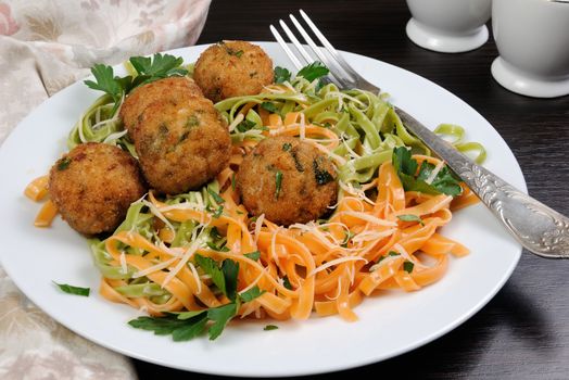 Spaghetti from carrots and spinach with chicken meatballs flavored cheese parmesan, herb