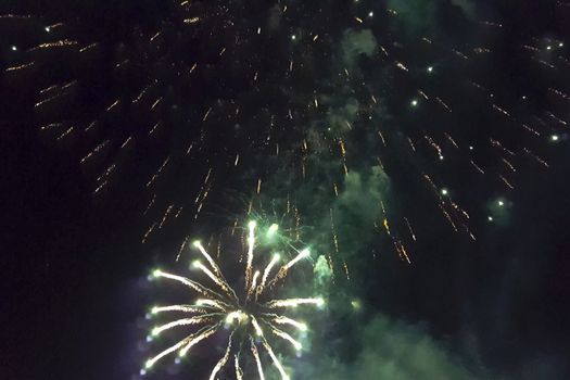 Festive salute in the night sky. Explosions of fireworks.