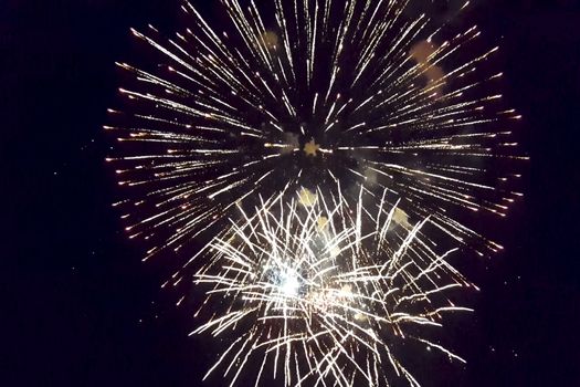 Festive salute in the night sky. Explosions of fireworks.