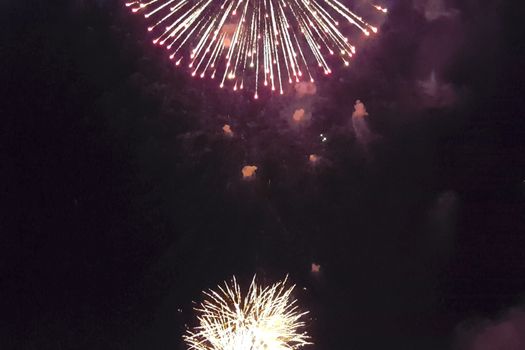 Festive salute in the night sky. Explosions of fireworks.