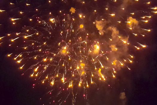 Festive salute in the night sky. Explosions of fireworks.