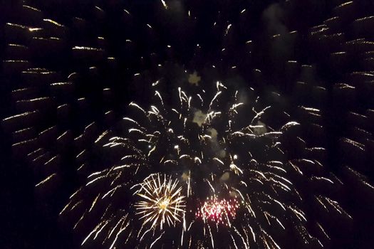 Festive salute in the night sky. Explosions of fireworks.