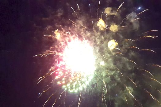 Festive salute in the night sky. Explosions of fireworks.