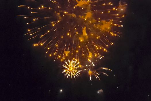 Festive salute in the night sky. Explosions of fireworks.