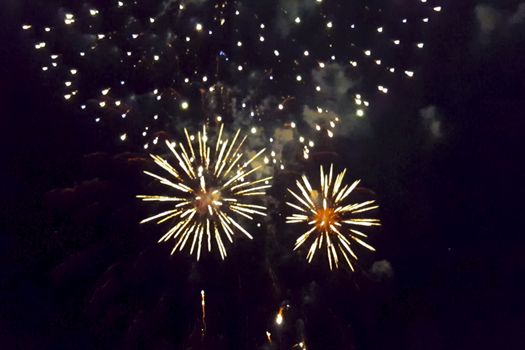 Festive salute in the night sky. Explosions of fireworks.