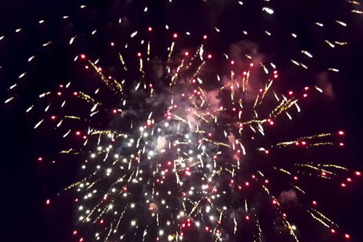 Festive salute in the night sky. Explosions of fireworks.