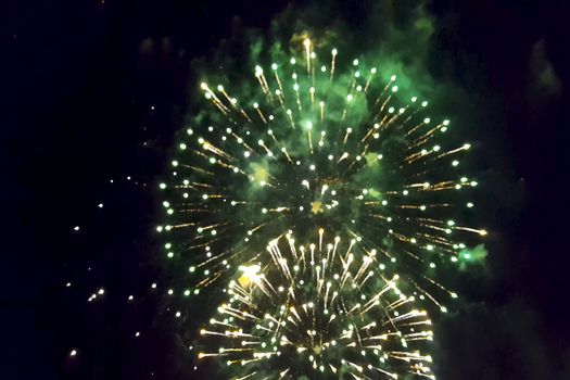 Festive salute in the night sky. Explosions of fireworks.