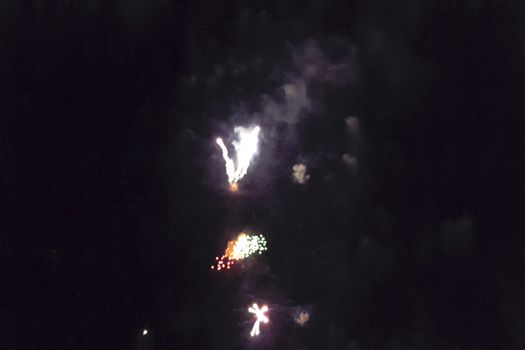 Festive salute in the night sky. Explosions of fireworks.