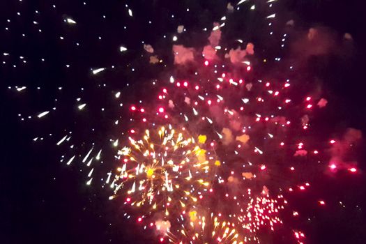 Festive salute in the night sky. Explosions of fireworks.