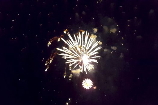 Festive salute in the night sky. Explosions of fireworks.