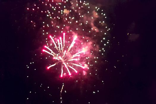 Festive salute in the night sky. Explosions of fireworks.