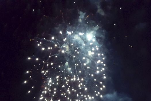 Festive salute in the night sky. Explosions of fireworks.