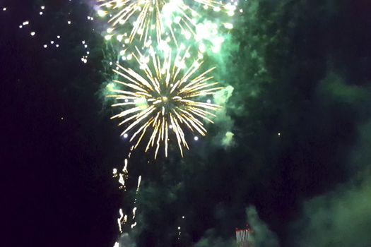 Festive salute in the night sky. Explosions of fireworks.