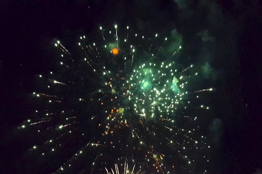 Festive salute in the night sky. Explosions of fireworks.