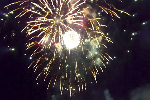 Festive salute in the night sky. Explosions of fireworks.