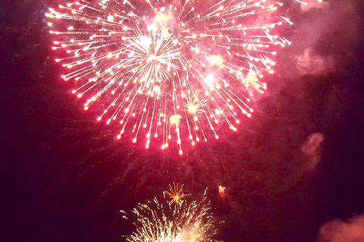 Festive salute in the night sky. Explosions of fireworks.