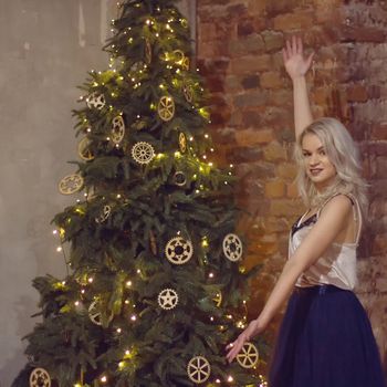 stylish happy woman decorating christmas tree.seasonal greetings concept