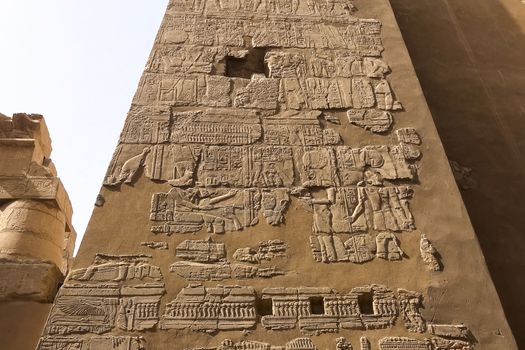 Egyptian hieroglyphs and drawings on the walls and columns. Egyptian language, The life of ancient gods and people in hieroglyphics and drawings